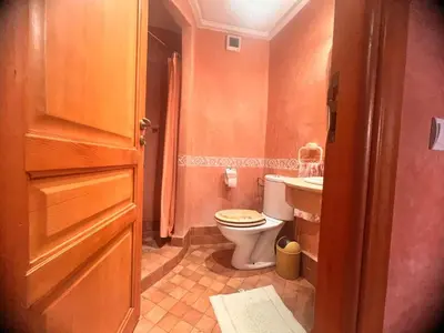 a small bathroom with a toilet and a sink at prestige andalouse 4 in Marrakech