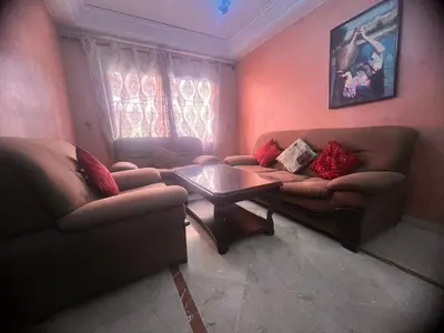 a living room with two couches and a coffee table at prestige andalouse 4 in Marrakech