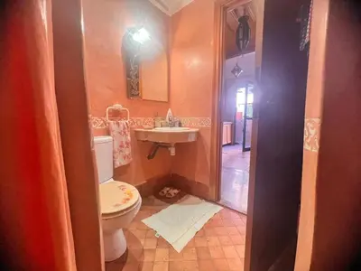 a bathroom with a toilet and a sink at prestige andalouse 4 in Marrakech