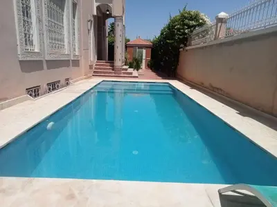 a blue swimming pool in the middle of a building at golf amelkis médina 1 N 50 in Marrakech