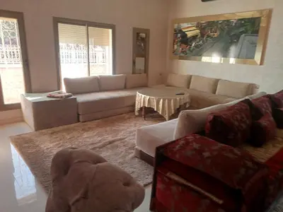 a living room with a couch and a table at golf amelkis médina 1 N 50 in Marrakech