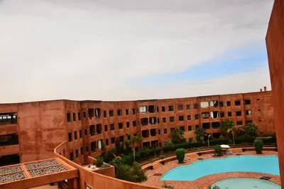 a view from the balcony of a building with a swimming pool at Oasis aux Palmeraies à Marrakech in Marrakech