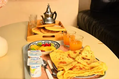 a table topped with a plate of food with toast at Oasis aux Palmeraies à Marrakech in Marrakech