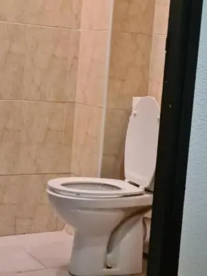 a bathroom with a white toilet in a room at Hotel Apart HLB in Marrakech
