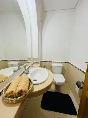 a bathroom with a sink and a toilet at Cosy Appartement Centre Gueliz avec piscine in Marrakech
