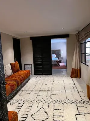 a living room with a couch and a bedroom at Dar Anacaona in Marrakech
