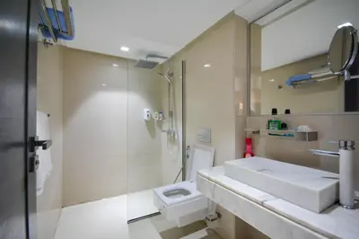 a bathroom with a sink and a shower and a toilet at Duplexe Luxueux de 2 Suites in Marrakech