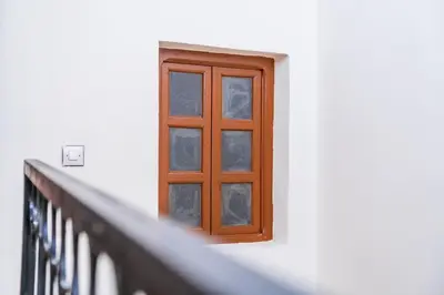 a window on the side of a white building at Riad 3 chambres - petit déjeuner gratuit - Top position in Marrakech