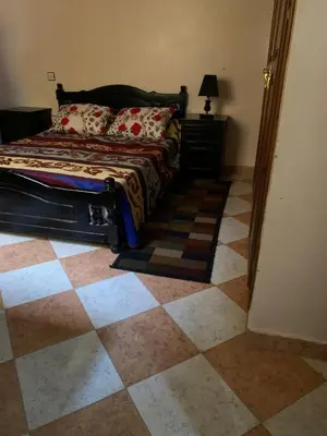 a bedroom with a bed and a checkered floor at Apparemment Aglmous in Marrakech