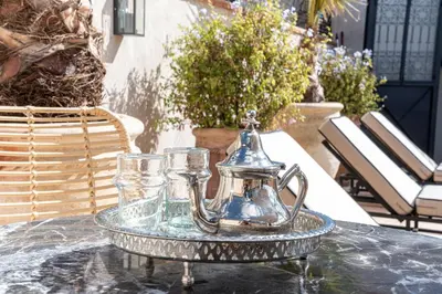 a tea kettle and glasses on a table at Riad COPAH in Marrakech