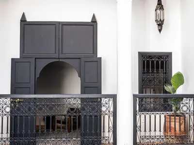 a black iron fence with a bottle of wine at Riad COPAH in Marrakech