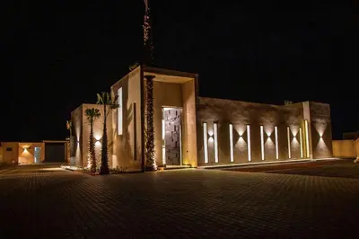 a building lit up at night with lights at Villa Palmeraie 4 suites zéro vis à vis in Marrakech