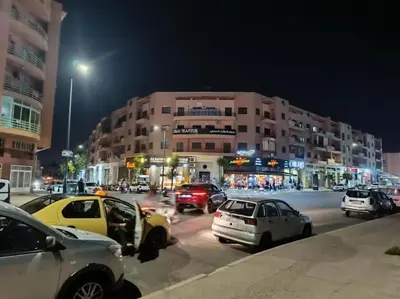 a busy city street at night with cars parked at Ruime 2 kamer appartement 5 min van het centrum in Marrakech