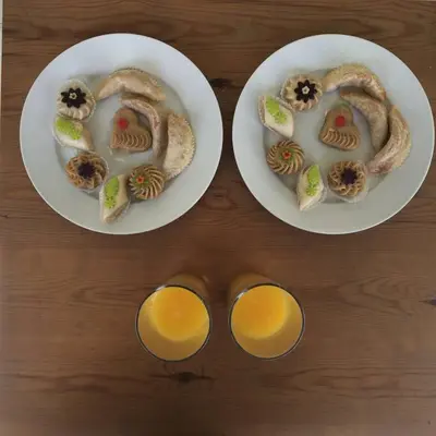 two plates of food and two cups of orange juice at Riad Charij in Marrakech