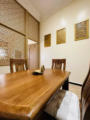 a wooden table in a room with chairs and a tableablish at Soleil de Medina in Marrakech