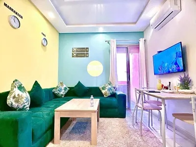 a living room with a green couch and a table at Apparemment in marrakech in Marrakech