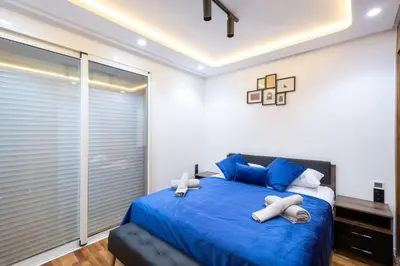 a bedroom with a blue bed with blue pillows at Chic 2 Bedroom with Mountain views Gueliz in Marrakech
