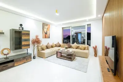 a living room with a couch and a tv at Luxury 2 Bedroom with Mountain View in Marrakech