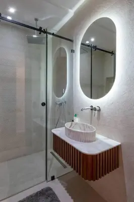 a bathroom with a sink and a shower with a mirror at Luxury 2 Bedroom with Mountain View in Marrakech