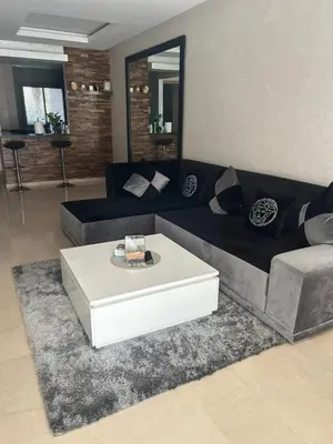 a living room with a couch and a coffee table at Prestigia corail in Marrakech