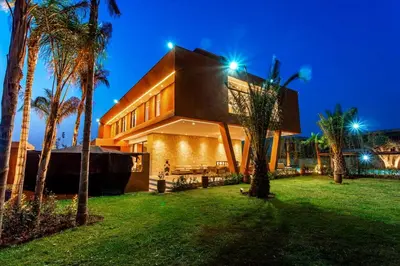 a house with palm trees in front of it at Villa Saphia K in Marrakech
