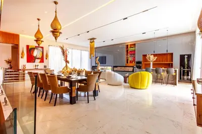 a dining room and living room with a table and chairs at Villa Saphia K in Marrakech
