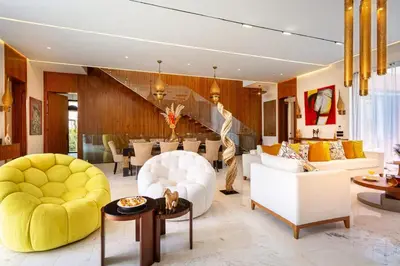 a living room with white furniture and yellow chairs at Villa Saphia K in Marrakech