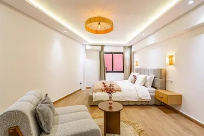 a living room with a bed and a couch at Verdelune Apartments in Marrakech