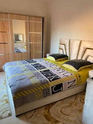 a large bed in a room with a couch at Apparemment in Marrakech