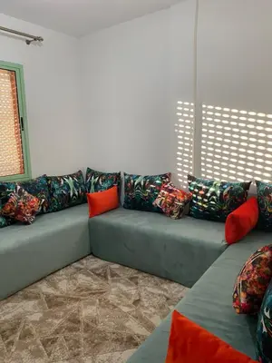 a couch with colorful pillows in a living room at Apparemment in Marrakech