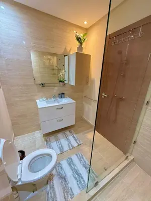 a bathroom with a toilet and a shower at Prestigia Marrakech golf city appartement 3 chambre in Marrakech