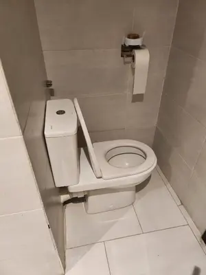 a bathroom with a white toilet in a stall at HOURIA LOC Marrakech in Marrakech