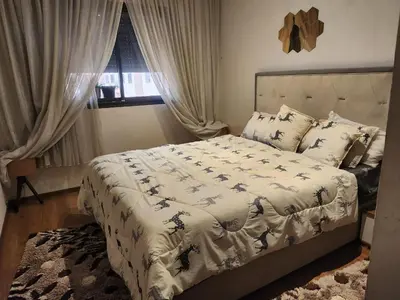 a bedroom with a large bed and a window at HOURIA LOC Marrakech in Marrakech