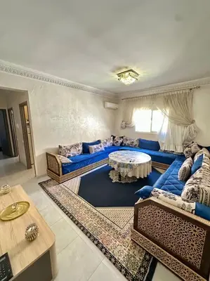 a living room with blue couches and a table at 2B Flat City Center Marrakech in Marrakech