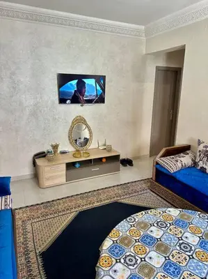 a bedroom with a tv on the wall and a bed at 2B Flat City Center Marrakech in Marrakech