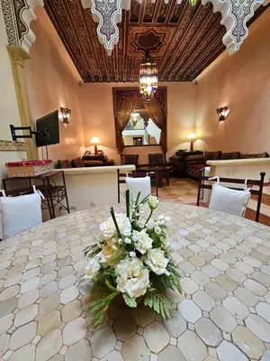 a vase of flowers on a table in a room at Mira Medina Garden in Marrakech