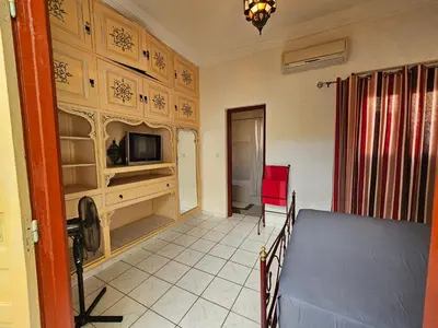a room with a table and a tv in a room at Mira Medina Garden in Marrakech