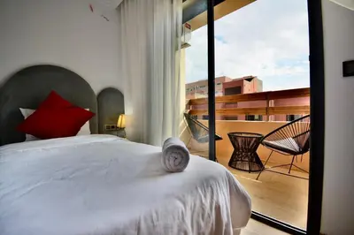 a bedroom with a large bed and a balcony at apart in the centre of marrakech gueliz in Marrakech