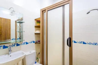a bathroom with a toilet and a sink and a shower at Jardins d'Anas Appartement Airport in Marrakech