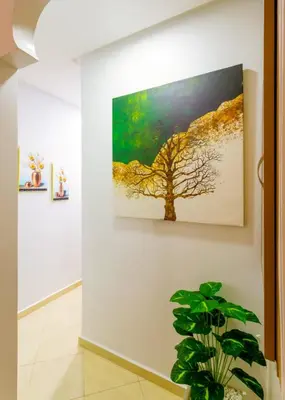 a painting of a tree on a wall at Jardins d'Anas Appartement Airport in Marrakech
