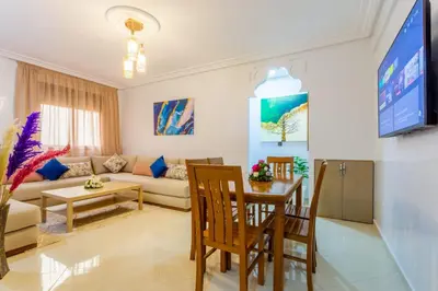 a living room with a couch and a table at Jardins d'Anas Appartement Airport in Marrakech