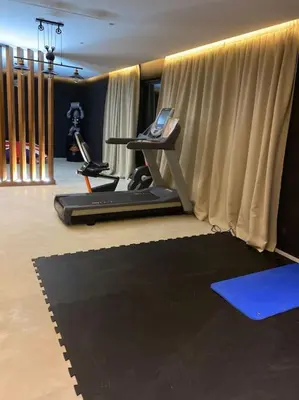 a room with a gym with a treadmill at Magnifique villa sur front de golf Amelkis in Marrakech