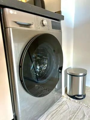 a washing machine with its door open in a room at Noria cosy & chic jardin privé in Marrakech