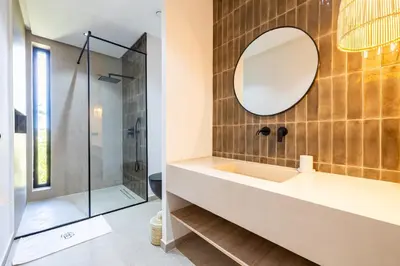a bathroom with a sink and a mirror at Villa 150 Amelkis 2-piscine chauffée in Marrakech