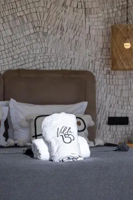 a pile of towels sitting on the floor in a bedroom at Villa 150 Amelkis 2-piscine chauffée in Marrakech