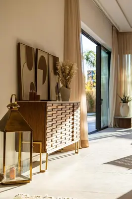a living room with a dresser and a large window at Villa 150 Amelkis 2-piscine chauffée in Marrakech