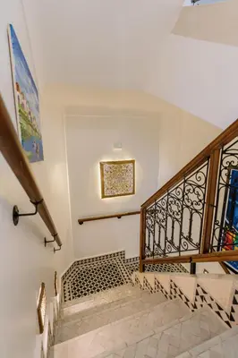 a staircase with a wrought iron railing and a stair case at Riad Cologne in Marrakech