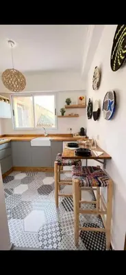 a kitchen with a table and a counter in a room at Dreamy Majorelle and Bohemian Majorelle in Marrakech