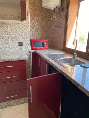a kitchen with a sink and a microwave on a counter at Full Moon APPARTS in Marrakech