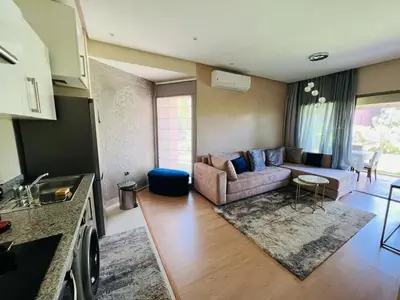 a living room with a couch and a table at Luxueux Prestigia golf city Marrakech in Marrakech